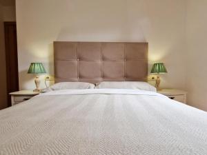 a bedroom with a large white bed with two lamps at Villmor - B53 - Coma De Albá, 1º in Benasque