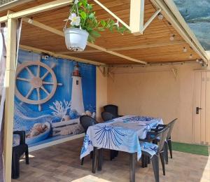 a dining room with a table and a painting of a lighthouse at Blu Panorama in Scilla