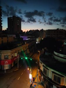 a city street at night with green traffic lights at Agora House for men only 仅限男性 in Alexandria