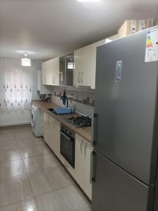 a kitchen with a refrigerator and a stove top oven at Casa Mathias in Buşteni
