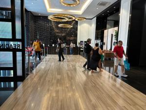 a group of people walking down a bowling alley at Chamber Luxury suites pwtc At KLCC in Kuala Lumpur +47 photos