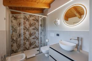 a bathroom with a shower and a sink and a mirror at B&B Ca' Marognole in Caprino Veronese +15 photos