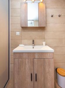 a bathroom with a sink and a mirror at Lila's Studios in Asprovalta +67 photos