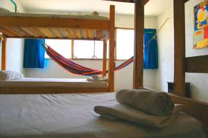 a bedroom with a bed and a window at Playa del Ritmo Beach Hostel & Bar - Adults Only in Santa Marta