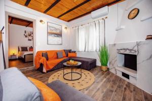 a living room with a couch and a fireplace at Lila's Studios in Asprovalta