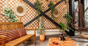 a room with a bench and a table with plants at Lila's Studios in Asprovalta