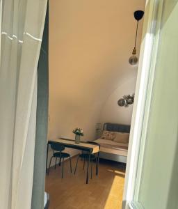 a small room with a table and a couch at Gaia Home in Capurso +3 photos