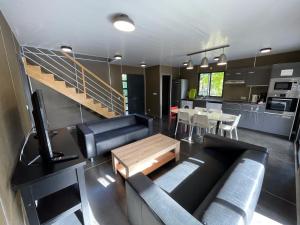 a living room with a couch and a table and a kitchen at Le Village de la Pointe in Le Vauclin