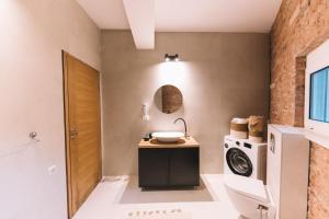 a bathroom with a sink and a washing machine at La Mer Beach Residence in Ulcinj