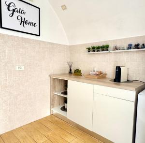 a kitchen with white cabinets and a counter top at Gaia Home in Capurso