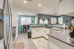 a kitchen with white cabinets and a dining room at Avondale Getaway Less Than 8 Mi to Estrella Mountain! in Avondale