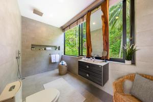 a bathroom with a sink and a toilet and a window at Villa Bond Seaview Villa in Chaweng Noi Beach +43 photos