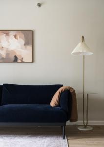 a blue couch in a living room with a lamp at Luxury Oasis Sleeps 8 King Bed Prime Location in Arlington