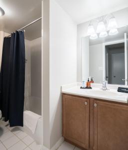 a bathroom with a sink and a shower and a mirror at Luxury Oasis Sleeps 8 King Bed Prime Location in Arlington +45 photos