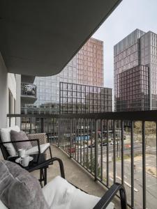 a balcony with a view of a city at Luxury Oasis Sleeps 8 King Bed Prime Location in Arlington