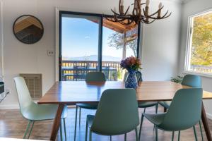 a dining room with a wooden table and chairs at Hot Tub, Panoramic Views, Deck, Firepit in Beech Mountain