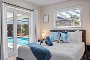 a bedroom with a bed and a swimming pool at Walk to Beach Indoor-Outdoor Living w Pool in Boca Raton +26 photos