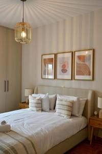 a bedroom with a large white bed with pillows at Acropoli 1 Bedroom Flat with Rooftop Acropolis View in Athens