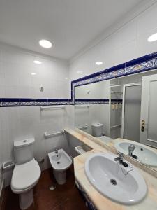 a bathroom with a sink and a toilet and a sink at Monte Treasure - Beach, Wifi, Pool, Parking in Monte Gordo