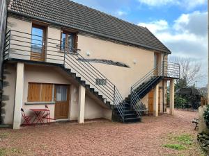 a house with a staircase on the side of it at Studio Revy 4 - Confort et équipé - Centre ville in Néris-les-Bains
