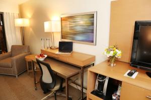 a hotel room with a desk with a laptop on it at enVision Hotel & Conference Center Mansfield-Foxboro in Mansfield