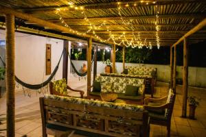 a patio with couches and a hammock and lights at Pousada Casa Imperatriz - Rua Teresa in Petrópolis