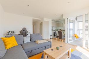 a living room with a couch and a table at Gorgeous 1Bd Flat with incredible views of the O2 in London