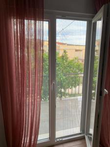 a sliding glass door with a view of a balcony at La Bandolaise à Perdika in Perdika
