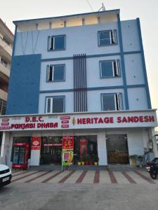 a large blue building with a sign in front of it at Heritage Sandesh in Haridwār