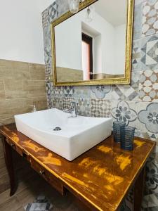 a bathroom with a white sink and a mirror at Casa Lulù in Cala Gonone