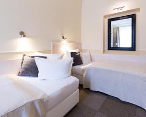 Giường trong phòng chung tại Unitas Hotel