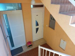 a staircase with a white door in a house at Apartment Jenul in Labin