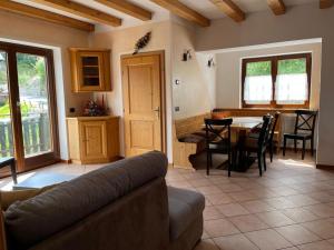 a living room with a couch and a table at Appartamento Candido Dolomiti CEDANOSTRA in Candide