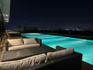 a view of a pool at night from a building at Niche Mono Mega Space Bangna1 in Bangna