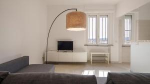 a living room with a couch and a flat screen tv at Panoramic Seaview in Olbia