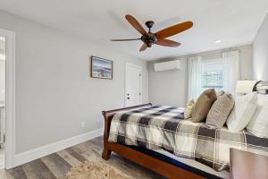 a bedroom with a bed with a ceiling fan at Cranmore Road 7 in North Conway +18 photos