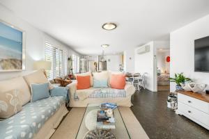 a living room with a couch and a table at Orford Coastal Retreat by Peppy Beach Retreats in Orford