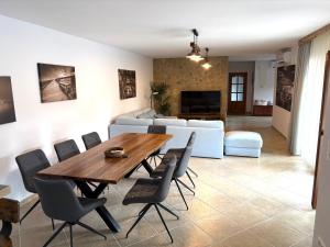 a living room with a wooden table and chairs at Bleu Fontaine in Kékkút