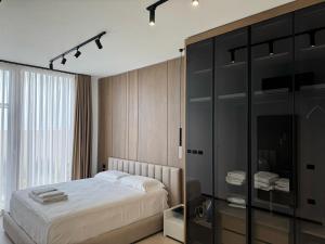 a bedroom with a bed and a glass cabinet at Aquazul, Green Coast in Palasë