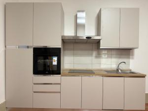a kitchen with white cabinets and a sink at Apt in the heart of Perugia, near Corso Vannucci in Perugia