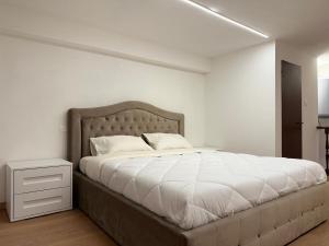 a bedroom with a large bed with white sheets at Apt in the heart of Perugia, near Corso Vannucci in Perugia