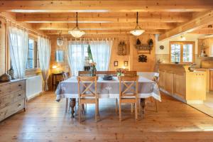 a kitchen with a table and chairs in a room at Chalet Les Patineurs in Champéry