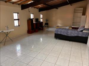 a bedroom with a bed and a tiled floor at Casa in Socorro