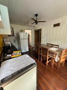 a kitchen and dining room with a table and a refrigerator at Casa da vó in Morretes