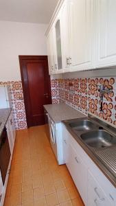 a kitchen with a sink and a counter top at Stella Marina 296 in Torvaianica +6 photos
