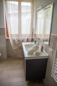 a bathroom with a sink and a mirror at Cà d'Nonu in Chiusa di Pesio