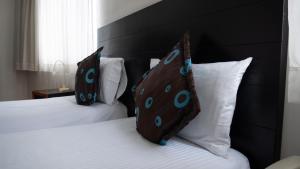 Ένα ή περισσότερα κρεβάτια σε δωμάτιο στο Benidorm Hotel