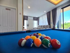 a group of balls on top of a pool table at Queen Ma Pool villa in Ban Nong Bua