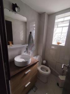 a bathroom with a sink and a toilet and a window at Casa Elysia in Kato Almiri +24 photos