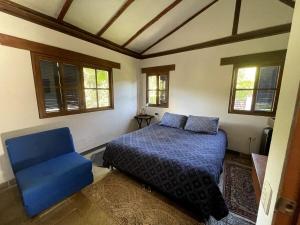a bedroom with a blue bed and a blue chair at Finca en La Mesa espectacular vista Descanso o trabajo in La Mesa +47 photos